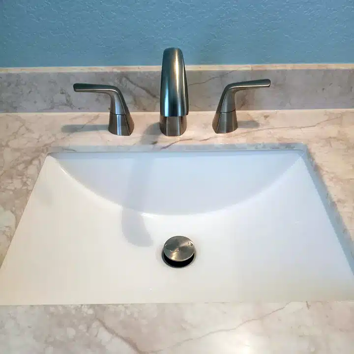 Sink and faucet installation in residential bathroom in Sugar Land, TX.