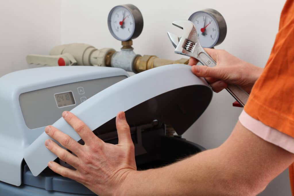 Plumber repairing water softener