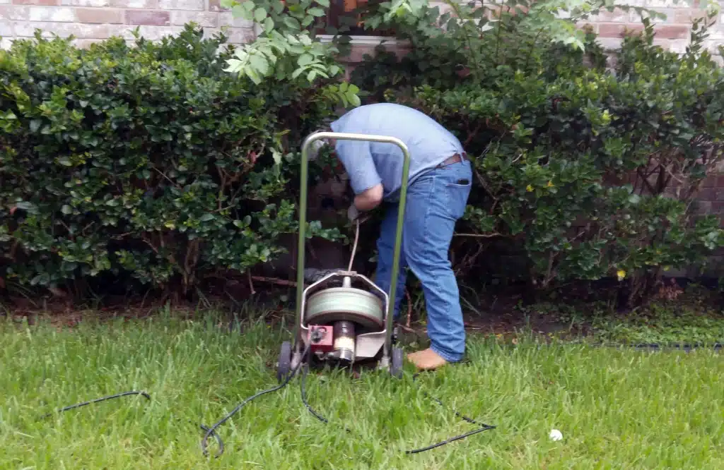 Doug Turner Plumbing tech using sewer machine in Sugar Land, TX.